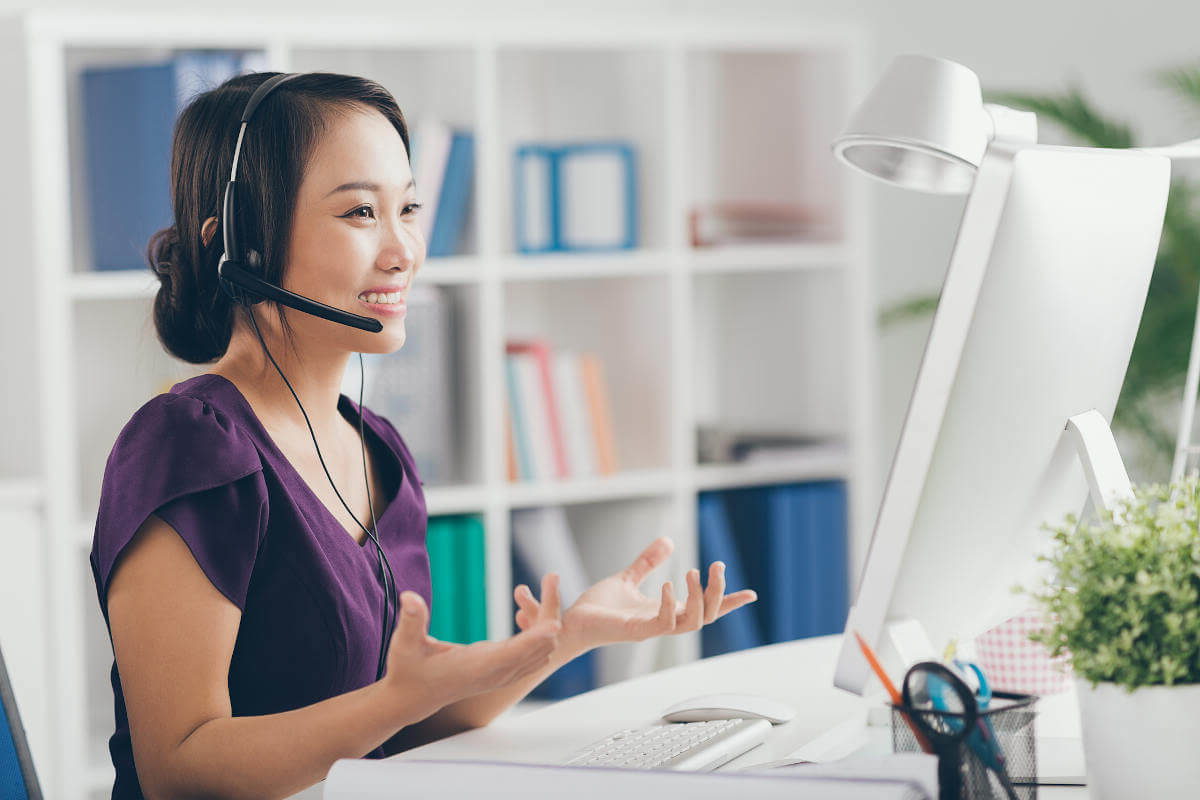 Filipina English teacher smiling in front of a computer screen